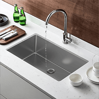 Kitchen faucet repositioned away from the disposal drain