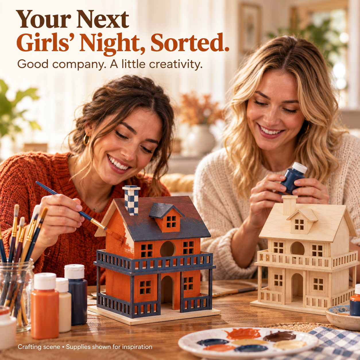 Two adult friends enjoying a painting session with miniature wooden houses