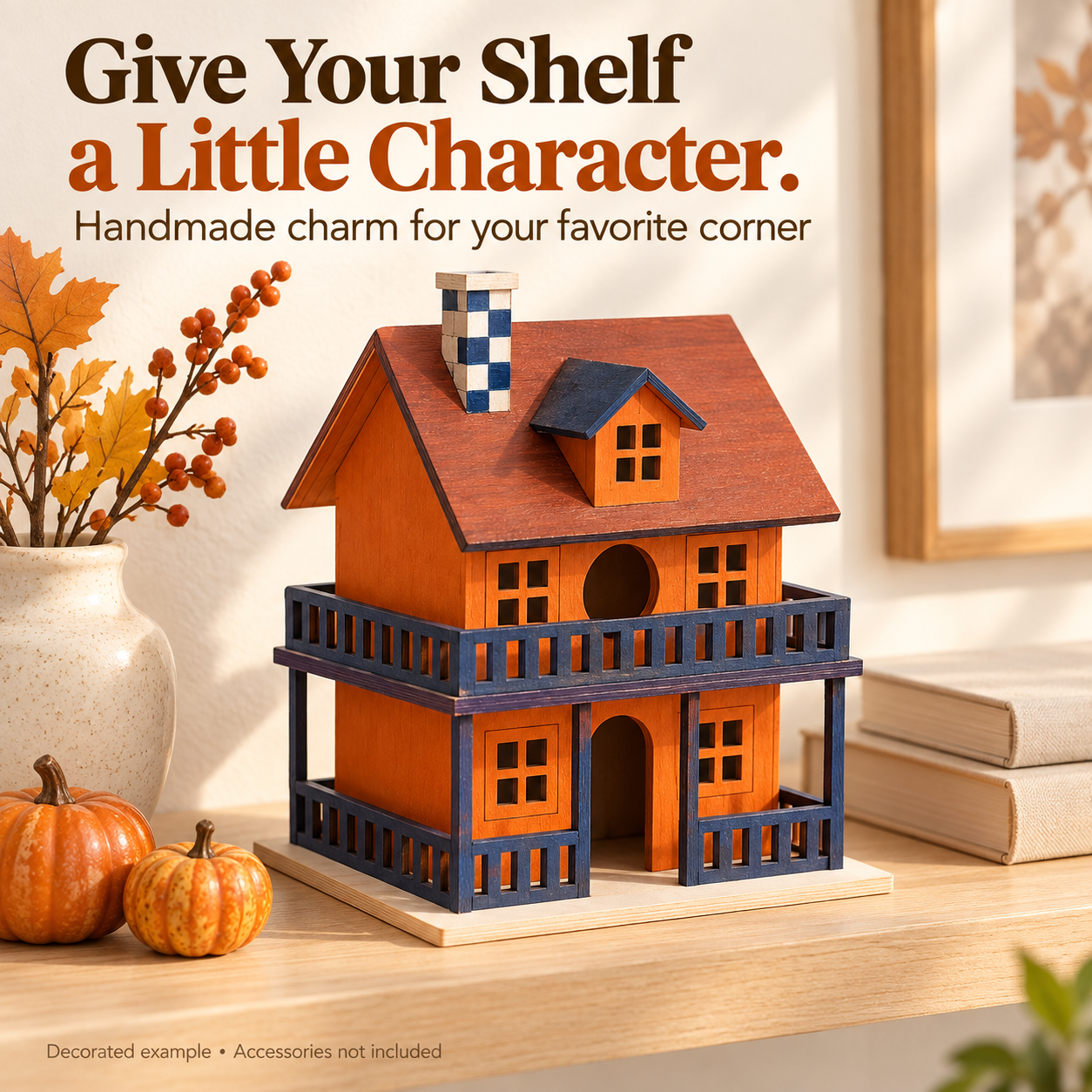Painted miniature house styled on an indoor shelf with autumn decor