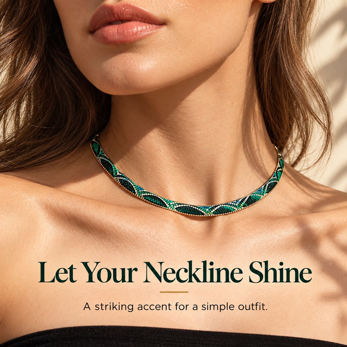 Green patterned statement necklace styled against a simple black neckline