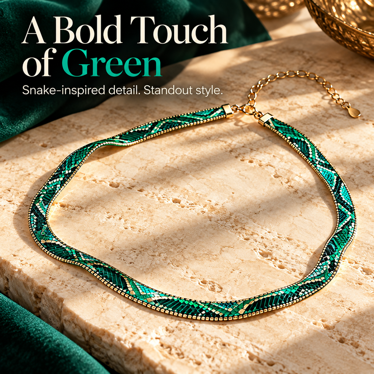 Green snake-pattern statement necklace arranged on a neutral surface with rich green fabric