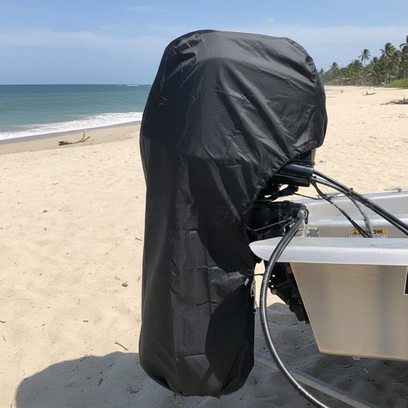 Outboard motor with protective cover at the beach